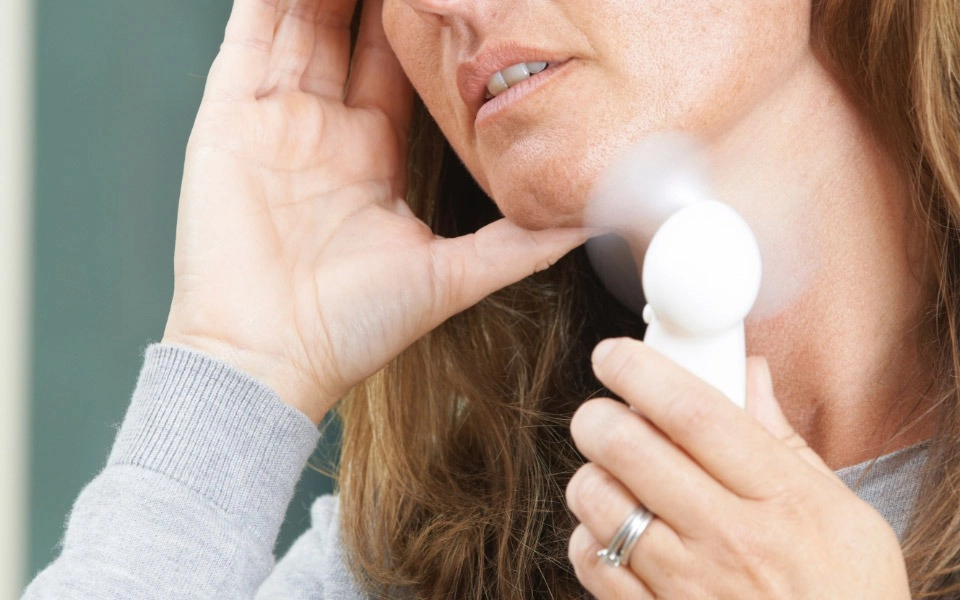 GROWTH SUPPLEMENTS - Imagem ilustrativa mulher com calor na menopausa