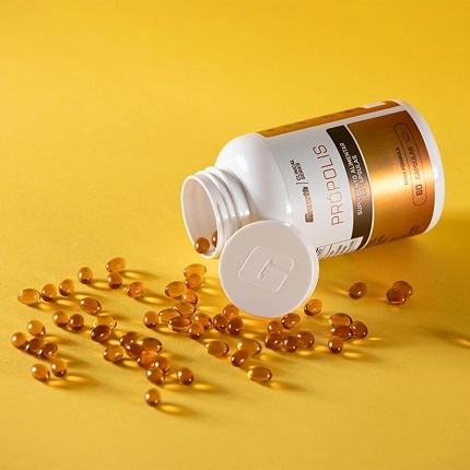 Growth Supplements - Imagem própolis em cima de uma mesa com um escudo brilhante ao redor e laranjas