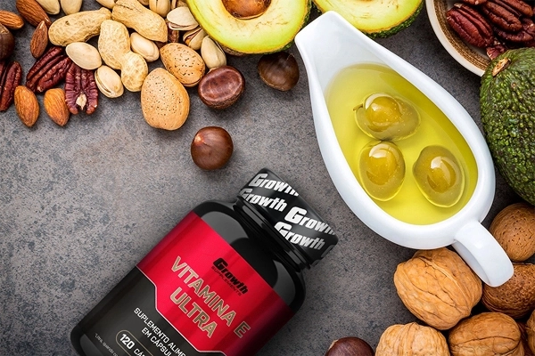 Growth Supplements - IMAGEM ILUSTRATIVA VITAMINA E EM UMA MESA ACOMPANHADA DE VARIOS ALINENTOS