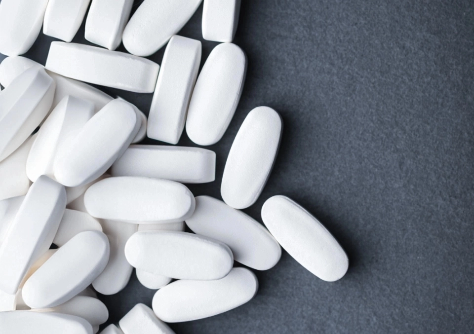 GROWTH SUPPLEMENTS - IMAGEM ILUSTRATIVA DAS PILULAS EM UM FUNDO CINZA